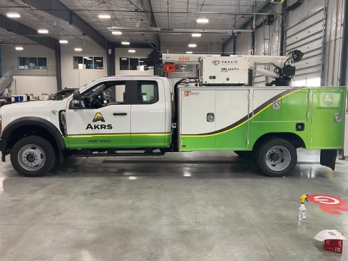 Partial wrap graphics on an AKRS Equipment service truck built by Revolution Wraps